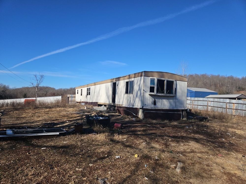 Manufactured home and surrounding existing conditions before demolition at the Salem, Arkansas project.