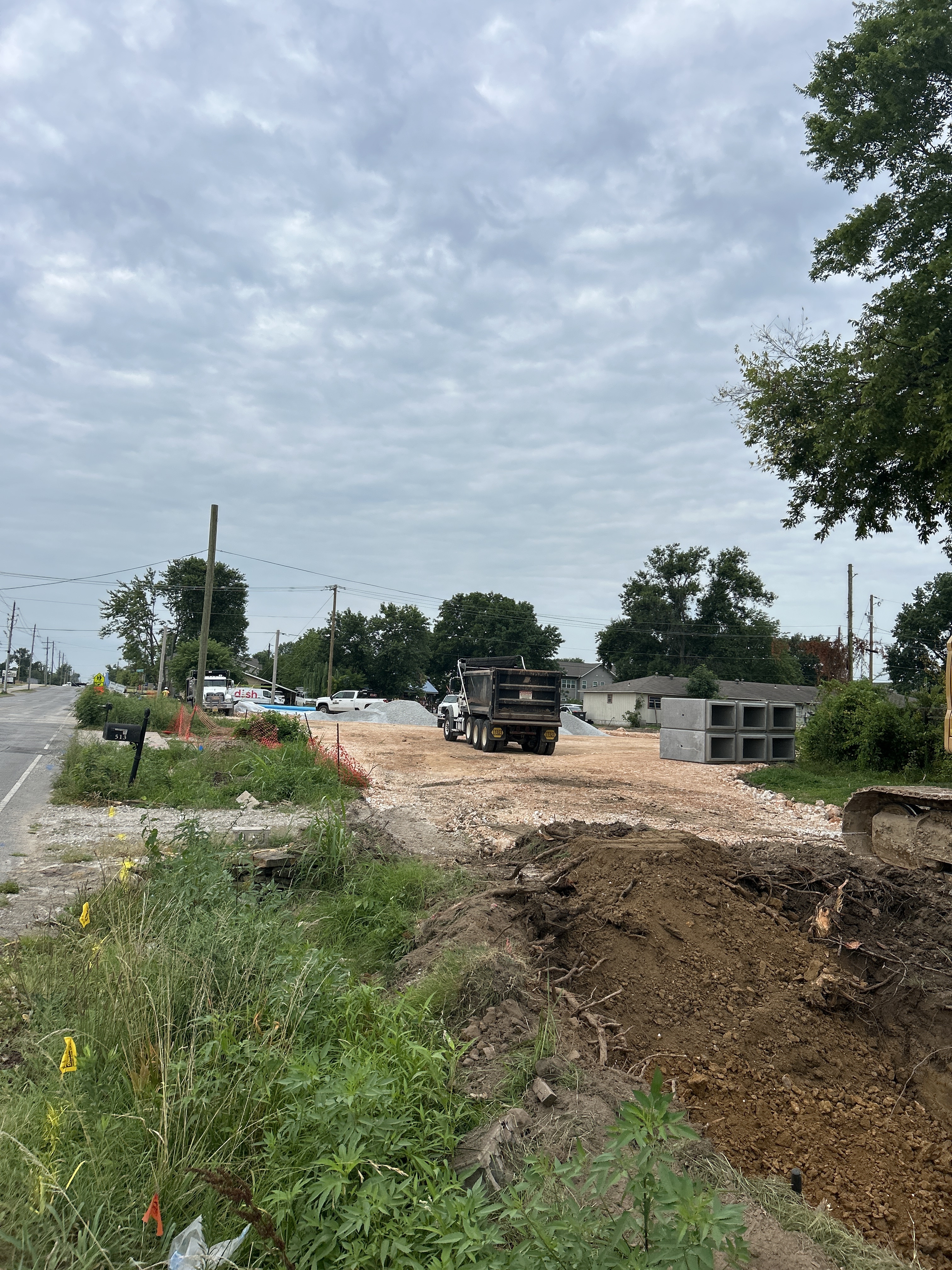 Later project condition with aggregate staging and construction activity at the Sunset and Powell Street Expansion Project in Springdale, Arkansas.