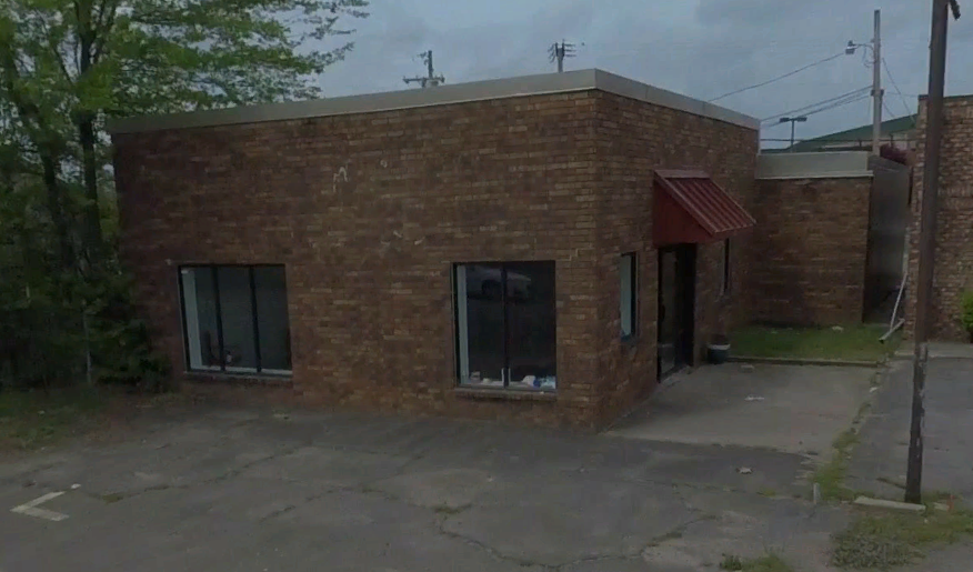 Existing commercial building at 603 Harkrider Street before removal.