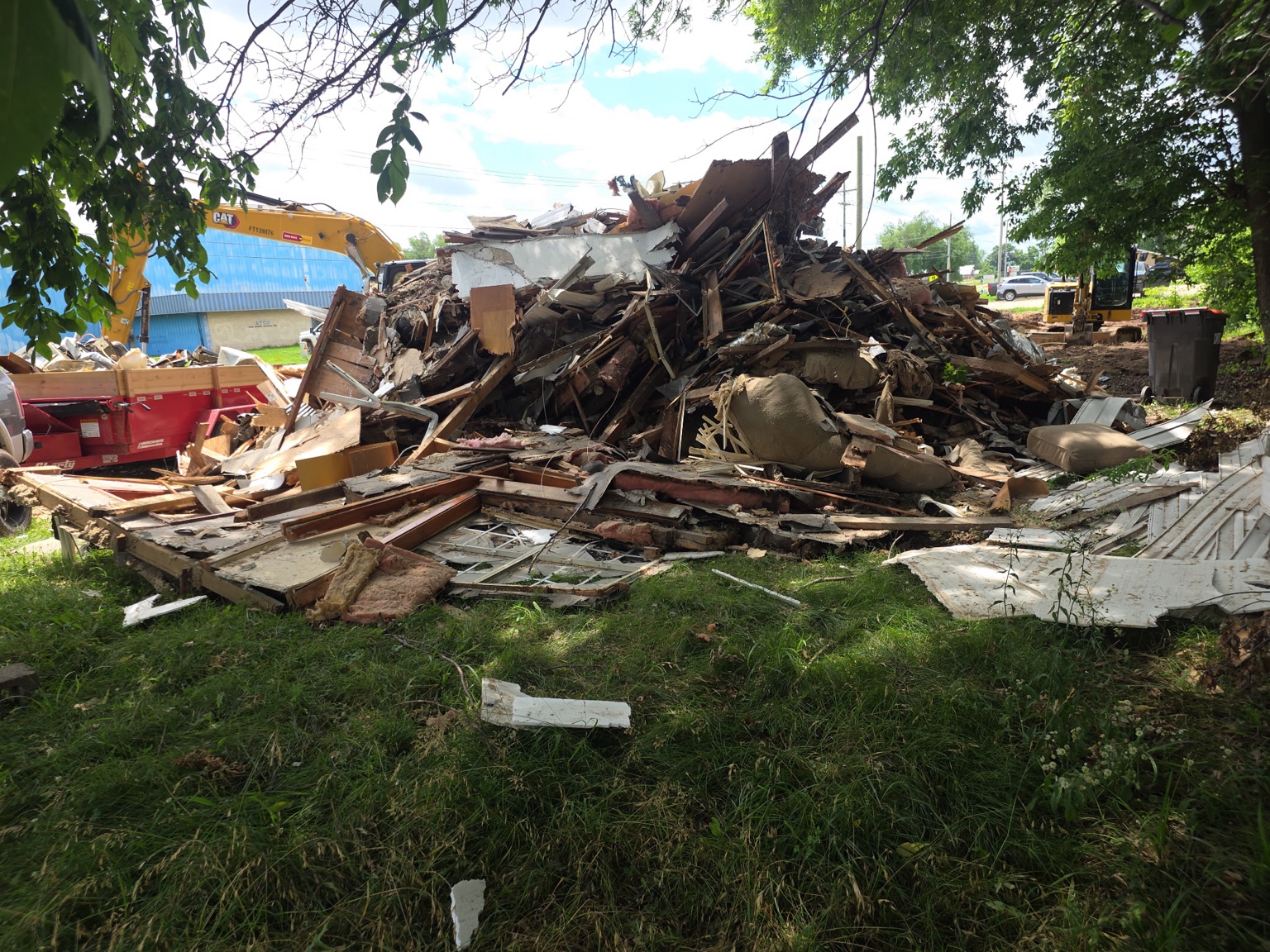 Demolition debris and excavator at the Sunset and Powell project in Springdale